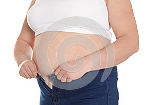Overweight woman trying to wear tight jeans 