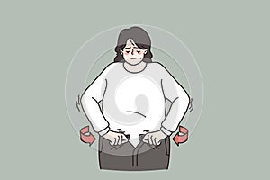 Overweight woman unable to fasten jeans belt