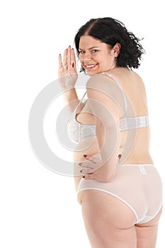 Overweight woman in underwear waving hello