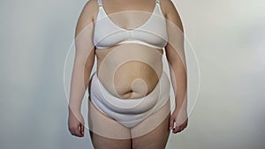 Overweight woman wearing undies posing for camera, obesity, unhealthy nutrition photo