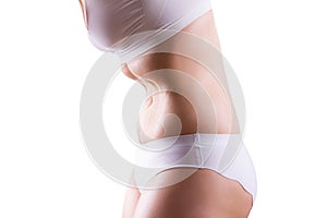 Overweight woman in white underwear doing vacuum exercise, isolated on white background