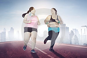 Overweight women running together at morning