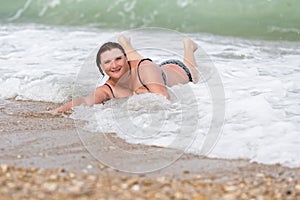 Overweight young woman at the sea