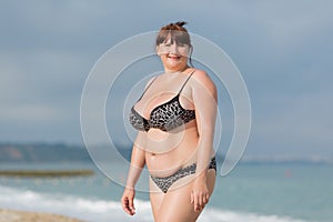 Overweight young woman at the sea