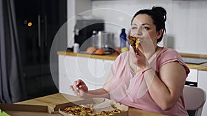 Overweighted woman eats with great pleasure, woman eats pizza, rolls eyes, slow motion