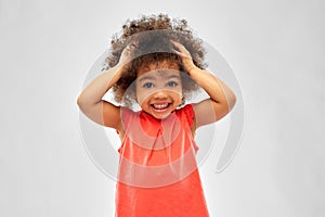 Overwhelmed african american girl holding to head photo