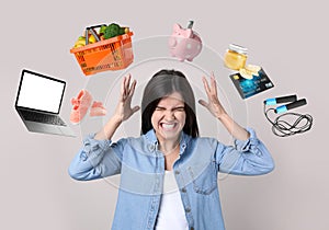 Overwhelmed woman and different objects around her on light grey background photo