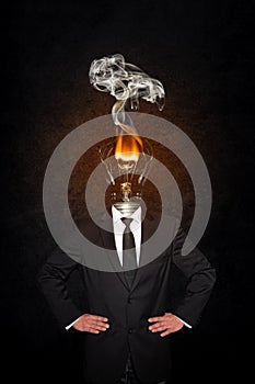 Overworked burnout business man standing headless with broken Bulb instead of his head. Symbolic Image - Stress Concept