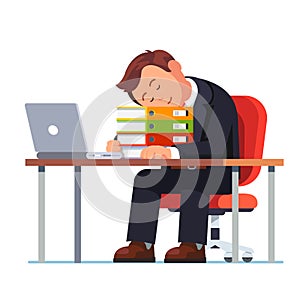 Overworked businessman falling asleep at his desk