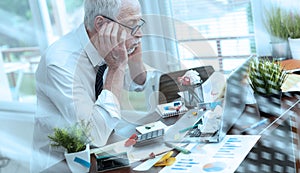 Overworked businessman sitting at a messy desk  light effect