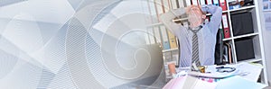 Overworked businessman sitting at a messy desk, panoramic banner