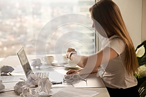 Overworked businesswoman looking at wristwatch, checking time to