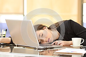 Overworked businesswoman sleeping at work photo