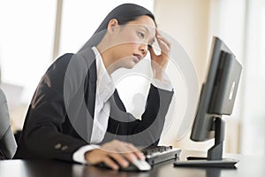 Overworked Businesswoman Working On Computer