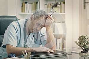 Overworked doctor in his office