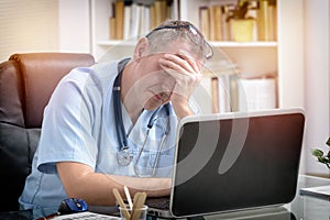 Overworked doctor in his office