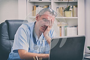 Overworked doctor in his office