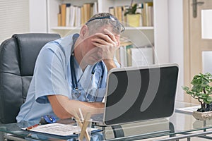 Overworked doctor in his office