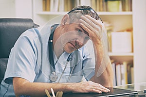 Overworked doctor in his office