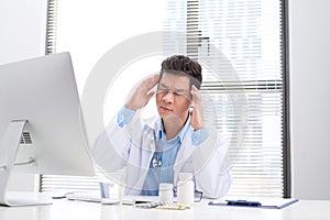 Overworked doctor sitting in his office