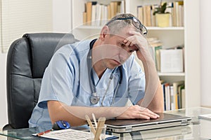 Overworked doctor in his office