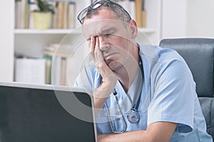 Overworked doctor in his office