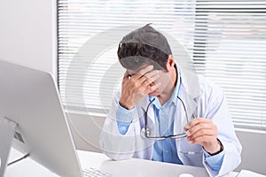 Overworked doctor sitting in his office