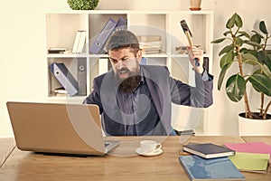 overworked man crush laptop with hammer. frustrated computer user. businessman express anger. ready to smash. Office