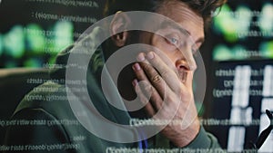 Overworked man rubbing eyes working data hologram closeup. Coder feeling tired