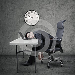 Overworked manager sleeping at desk