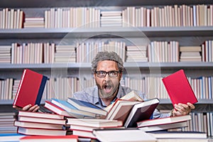 overworked millenial student read book. overworked man student reading book in a book store or school library