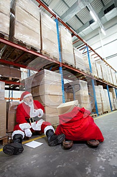 Overworked santa claus with pain in chest photo