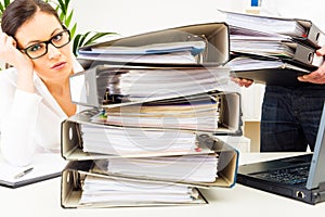 Overworked Secretary With Folders