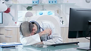 Overworked sicentist or doctor in his modern office