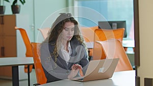 Overworked tired busy woman closing laptop leaning on chair sitting in office indoors. Portrait of exhausted