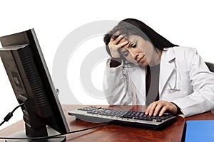 Overworked tired doctor at computer photo