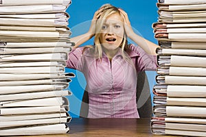 Overworked woman at the office desk