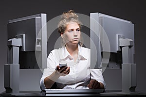 Overworked woman sitting at computers