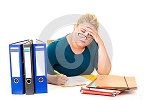 Overworked young businesswoman at desk on white