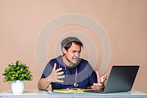 Overworked young doctor sitting in his office