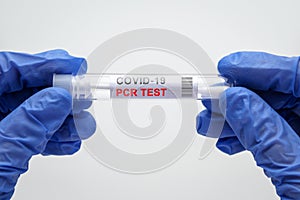 OVID-19 PCR test in doctor hands close-up, nurse holds coronavirus swab collection kit