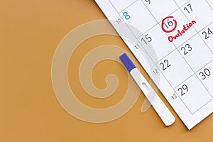 Ovulation home test on calendar with ovulation day red mark