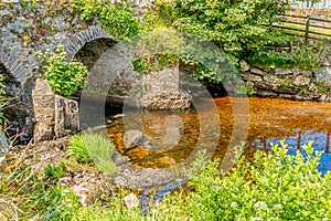 Owenglin or Owenglen river with the Ardbear Old Bridge with clean and transparent water