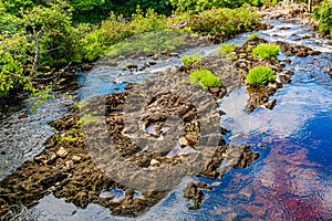 Owenglin or Owenglen river with a low flow with limestone rocks between the river stream