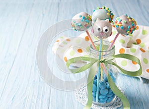 Owl cake pops with multi coloured sprinkles in the bottle with blue smarties, sweet food for kids