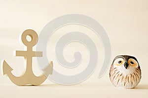 Owl ceramic in vintage with wooden anchor in decorative background