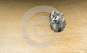 Owl pellet with bones on a wooden background