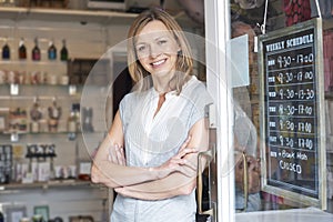 Owner Of Gift Shop Standing In Doorway