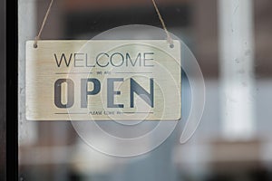 Welcome open shop barista waitress open sign on glass door modern coffee shop ready to serve cafe restaurant retail store small bu