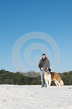 Owner with rescue dog in snow